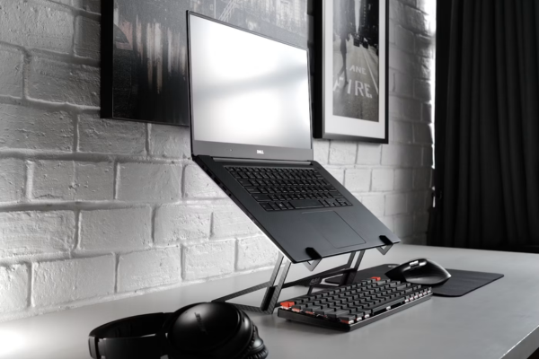 A desk with the laptop raised to eye level